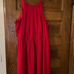 A red dress, it’s missing a belt. And it comes up to the knee